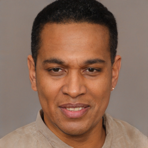 Joyful latino adult male with short  black hair and brown eyes