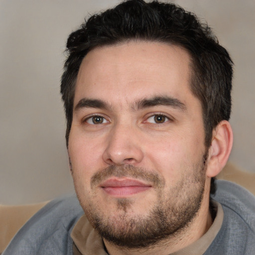 Joyful white young-adult male with short  black hair and brown eyes