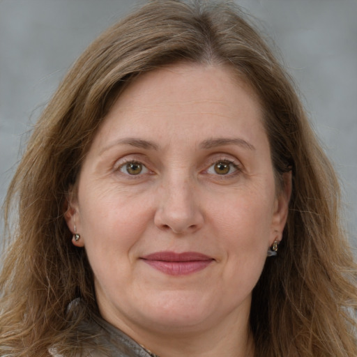 Joyful white adult female with long  brown hair and green eyes