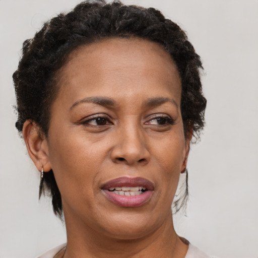 Joyful black adult female with short  brown hair and brown eyes