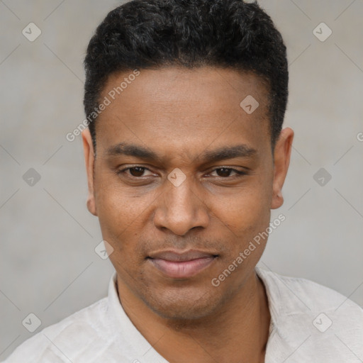 Joyful black young-adult male with short  black hair and brown eyes