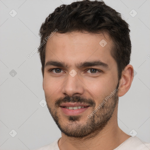 Joyful white young-adult male with short  black hair and brown eyes