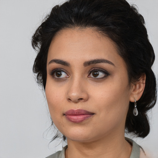 Joyful latino young-adult female with medium  black hair and brown eyes