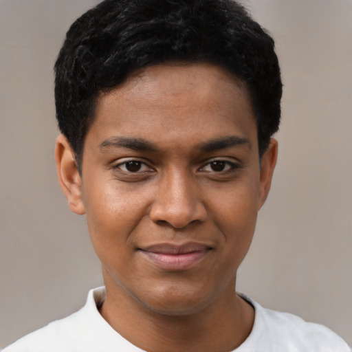 Joyful black young-adult male with short  black hair and brown eyes