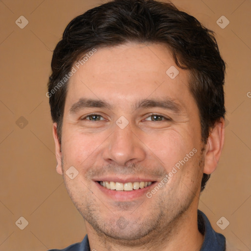 Joyful white adult male with short  brown hair and brown eyes