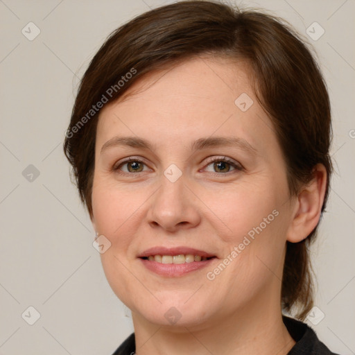 Joyful white young-adult female with medium  brown hair and green eyes