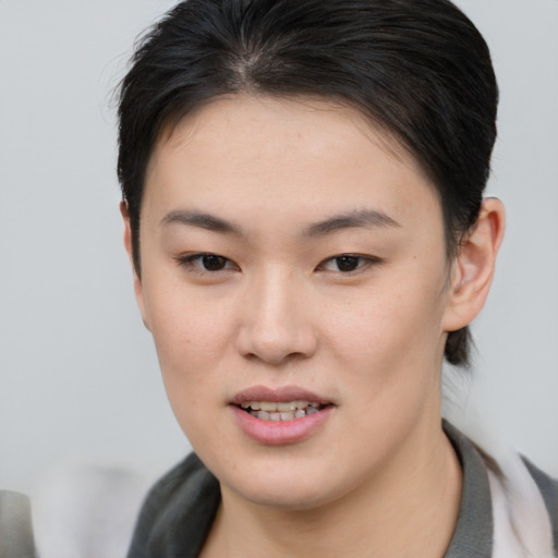 Joyful asian young-adult female with short  brown hair and brown eyes