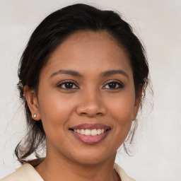 Joyful latino young-adult female with medium  brown hair and brown eyes