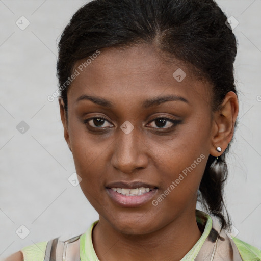 Joyful black young-adult female with short  brown hair and brown eyes