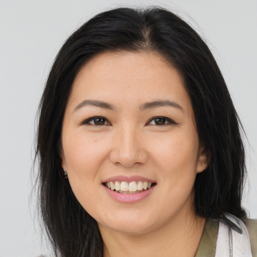 Joyful asian young-adult female with medium  brown hair and brown eyes