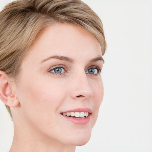 Joyful white young-adult female with short  brown hair and blue eyes