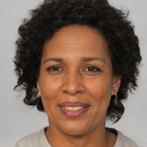 Joyful black adult female with short  brown hair and brown eyes