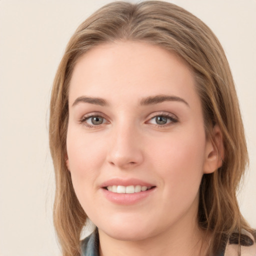 Joyful white young-adult female with long  brown hair and grey eyes