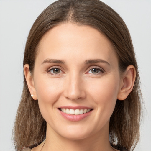 Joyful white young-adult female with long  brown hair and brown eyes