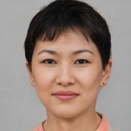 Joyful asian young-adult female with short  brown hair and brown eyes