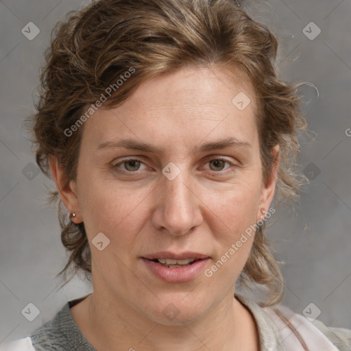 Joyful white adult female with medium  brown hair and blue eyes