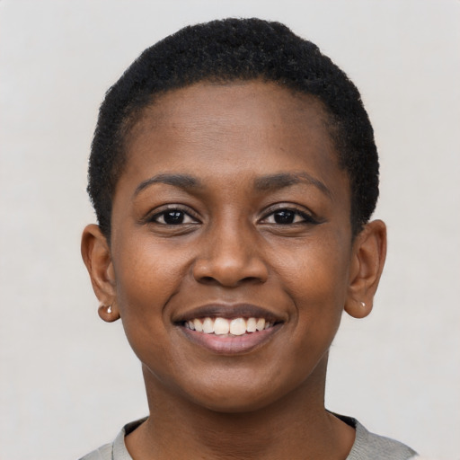 Joyful black young-adult female with short  black hair and brown eyes