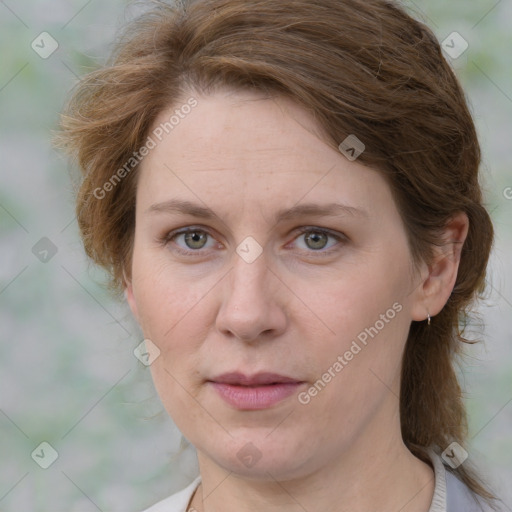 Joyful white adult female with medium  brown hair and green eyes