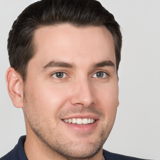 Joyful white young-adult male with short  brown hair and brown eyes