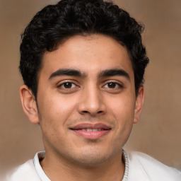 Joyful latino young-adult male with short  brown hair and brown eyes