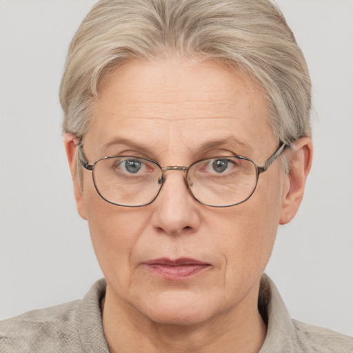 Neutral white middle-aged female with short  gray hair and blue eyes