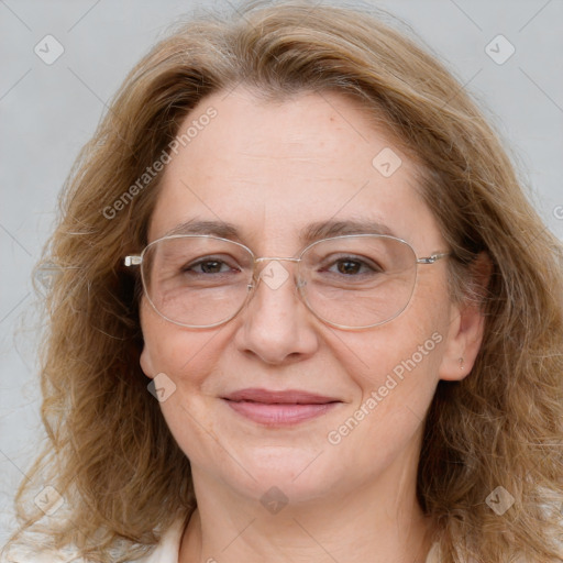 Joyful white adult female with long  brown hair and brown eyes