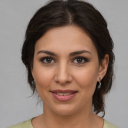 Joyful white young-adult female with medium  brown hair and brown eyes