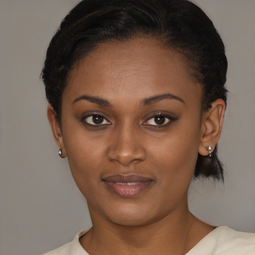 Joyful black young-adult female with short  brown hair and brown eyes