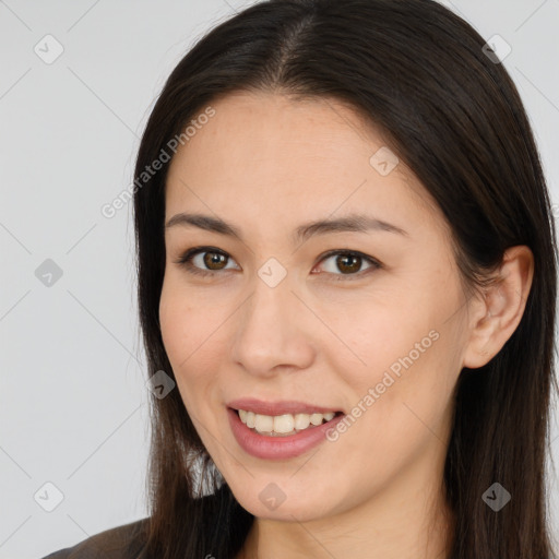 Joyful white young-adult female with long  brown hair and brown eyes