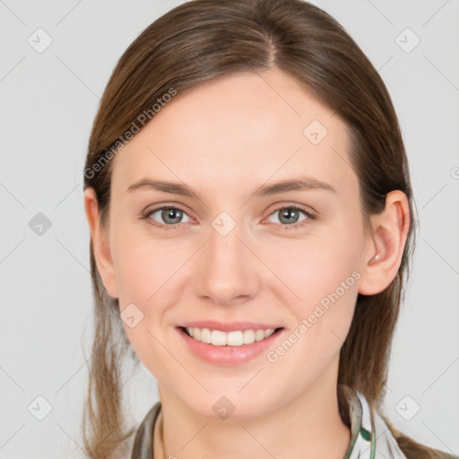 Joyful white young-adult female with medium  brown hair and grey eyes