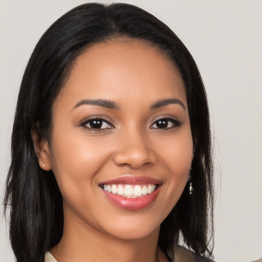 Joyful latino young-adult female with long  black hair and brown eyes