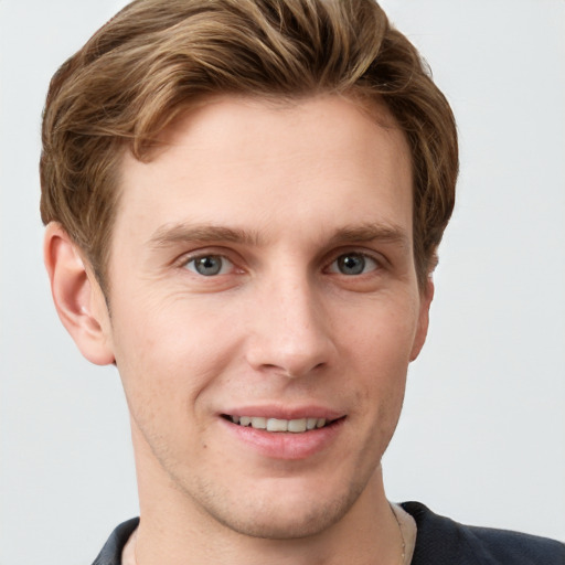 Joyful white young-adult male with short  brown hair and grey eyes