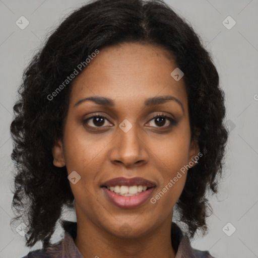 Joyful black young-adult female with long  brown hair and brown eyes