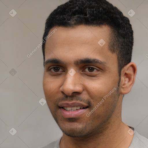 Joyful black young-adult male with short  black hair and brown eyes