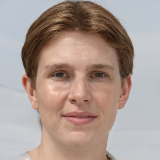 Joyful white adult female with short  brown hair and grey eyes