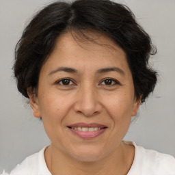 Joyful white adult female with medium  brown hair and brown eyes