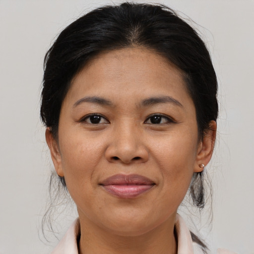 Joyful asian adult female with medium  brown hair and brown eyes