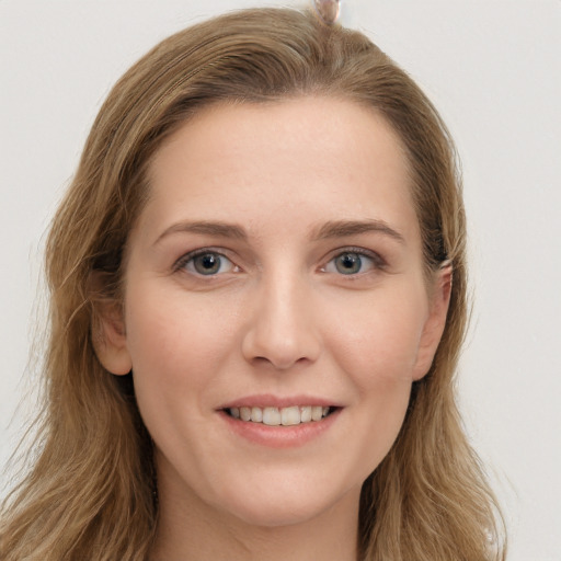 Joyful white young-adult female with long  brown hair and grey eyes