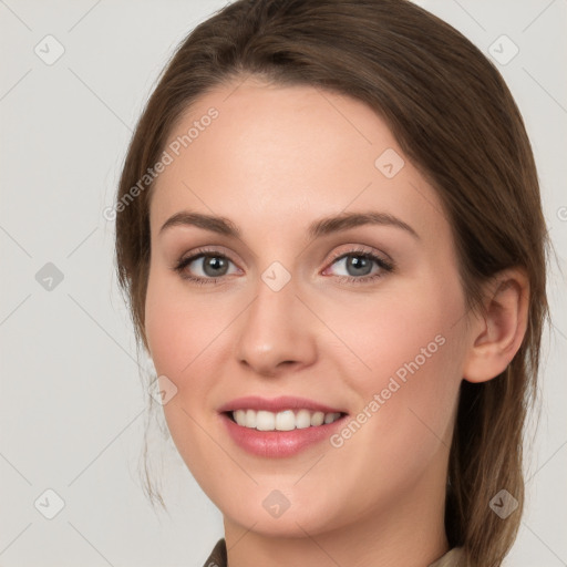 Joyful white young-adult female with medium  brown hair and grey eyes