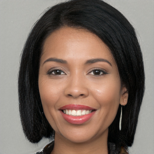 Joyful latino young-adult female with long  brown hair and brown eyes