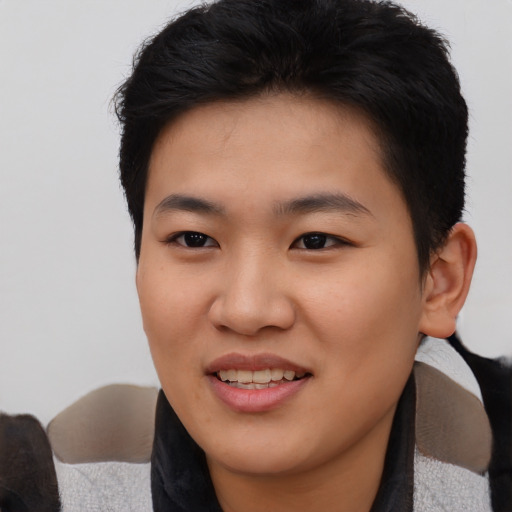 Joyful asian young-adult female with short  black hair and brown eyes