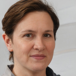 Joyful white adult female with medium  brown hair and brown eyes