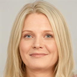 Joyful white young-adult female with long  blond hair and blue eyes