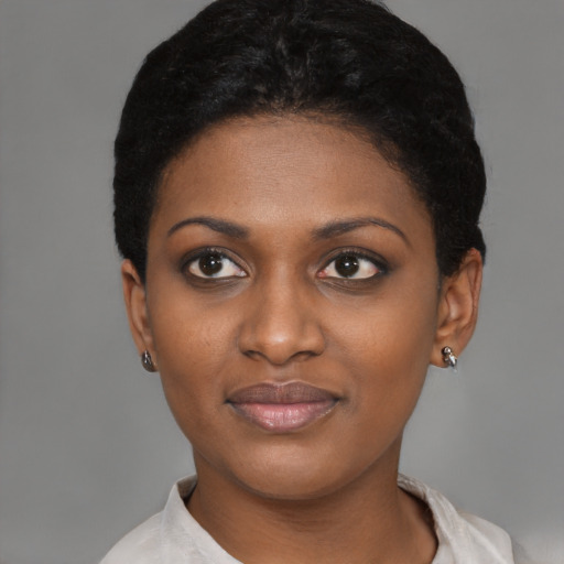 Joyful black young-adult female with short  black hair and brown eyes