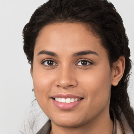 Joyful white young-adult female with long  brown hair and brown eyes