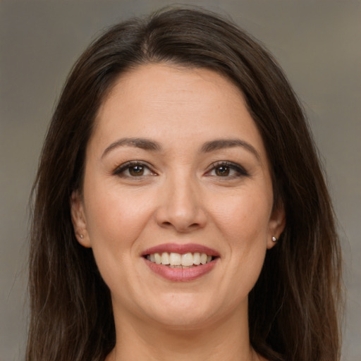 Joyful white young-adult female with long  brown hair and brown eyes