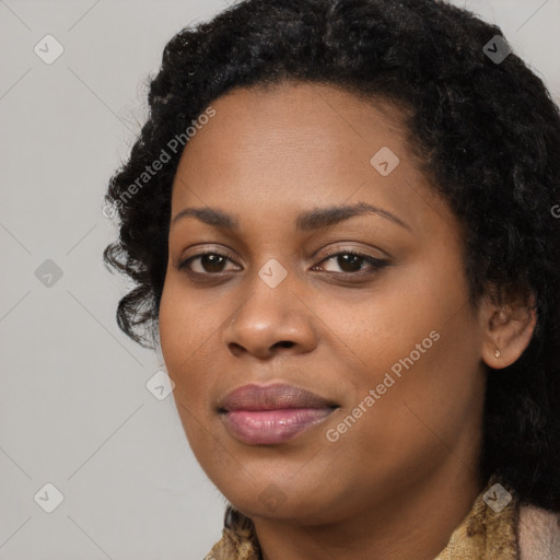 Joyful black young-adult female with long  black hair and brown eyes