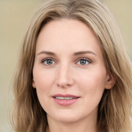 Joyful white young-adult female with long  brown hair and green eyes