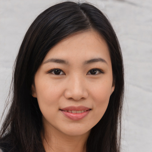 Joyful asian young-adult female with long  brown hair and brown eyes