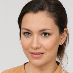 Joyful white young-adult female with medium  brown hair and brown eyes